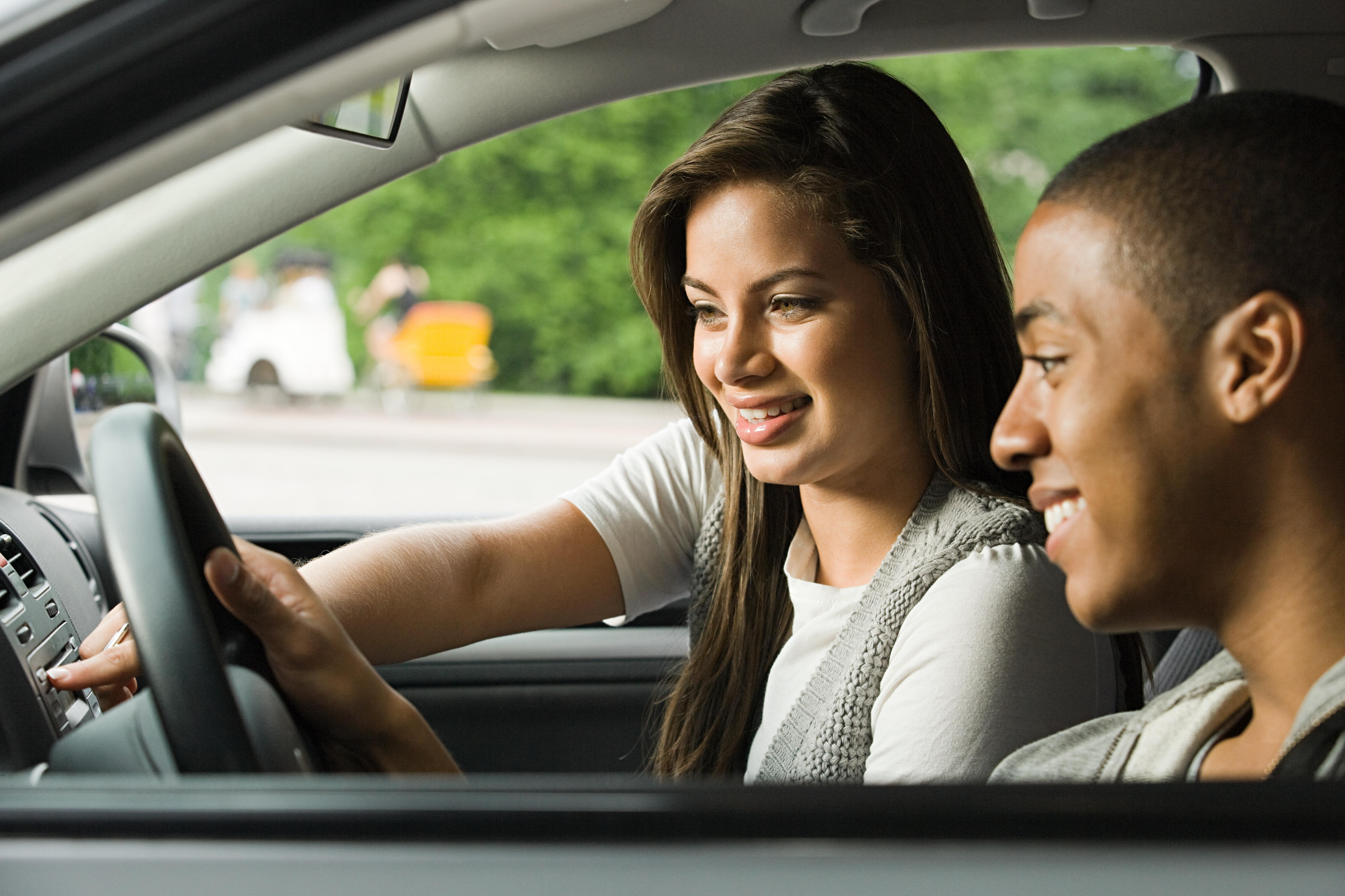 Smiling young couple in a car
