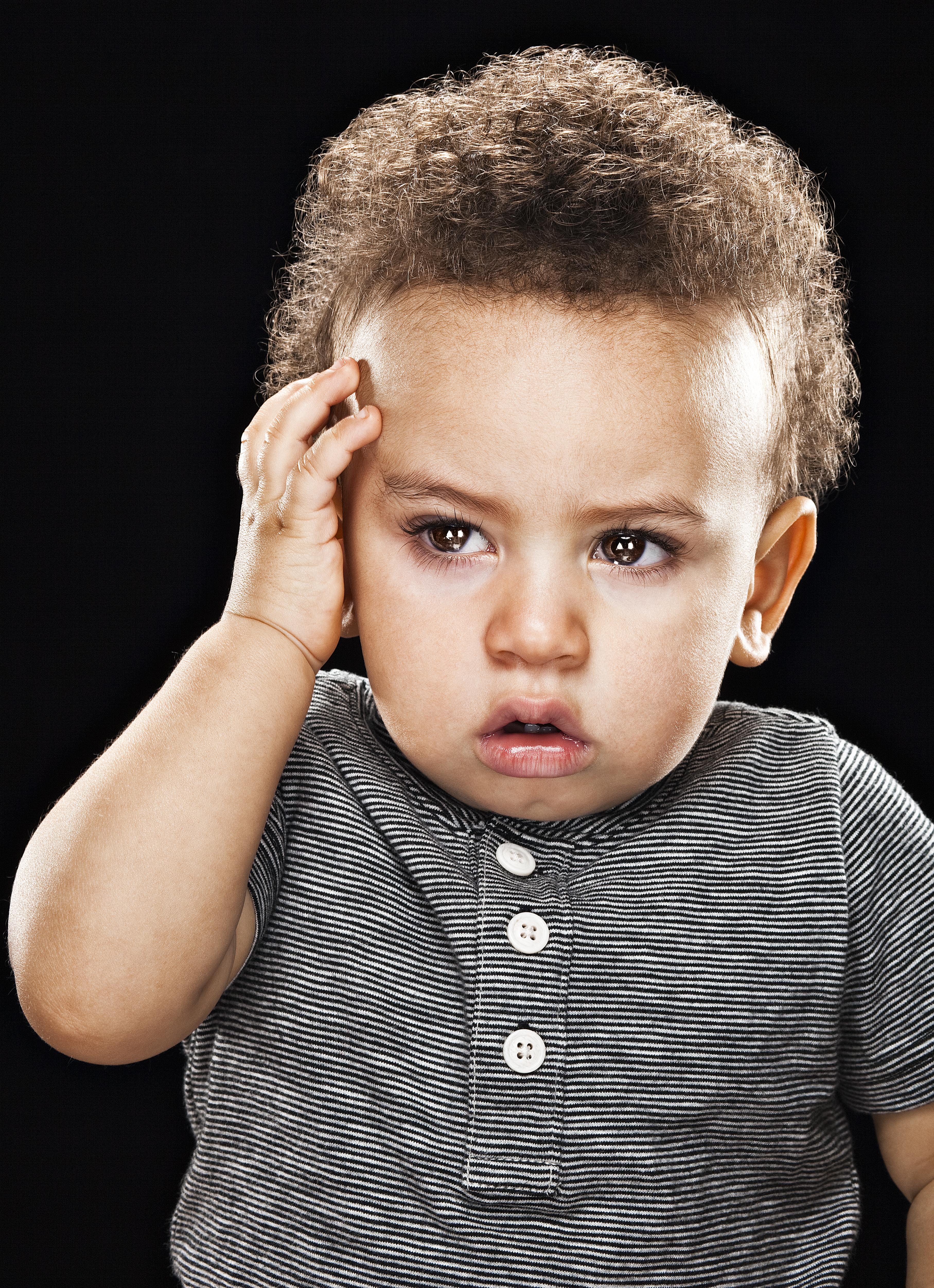 Baby holding head looking tired