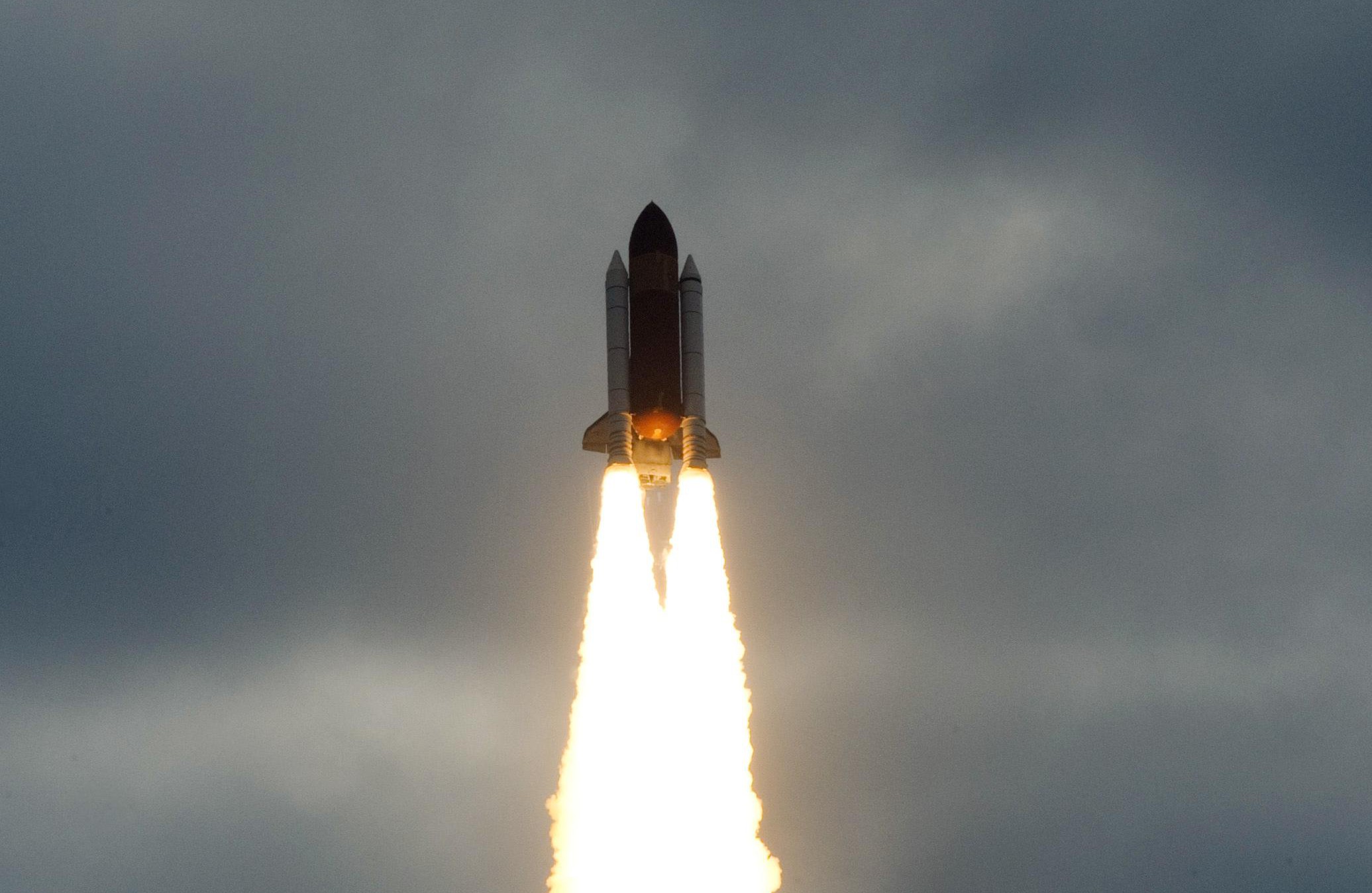 The Space Shuttle Endeavour flies into t