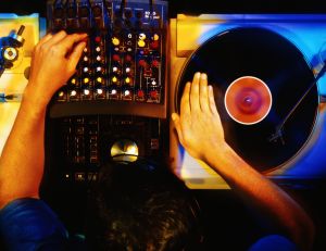 Disc jockey working with vinyl records, overhead view