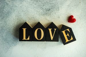 Word LOVE written with wooden blocks and a heart shape decoration
