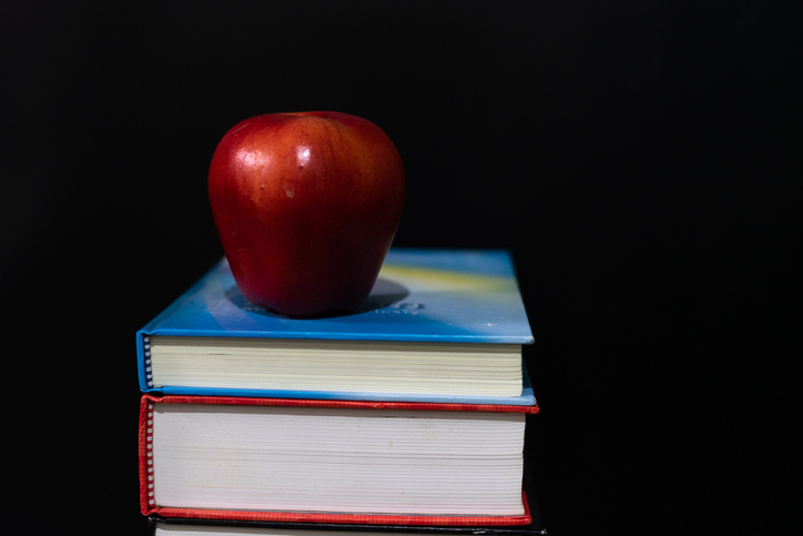 Red apple on books.