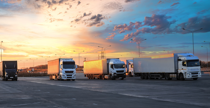 Trucks in parking lot on suburban highway