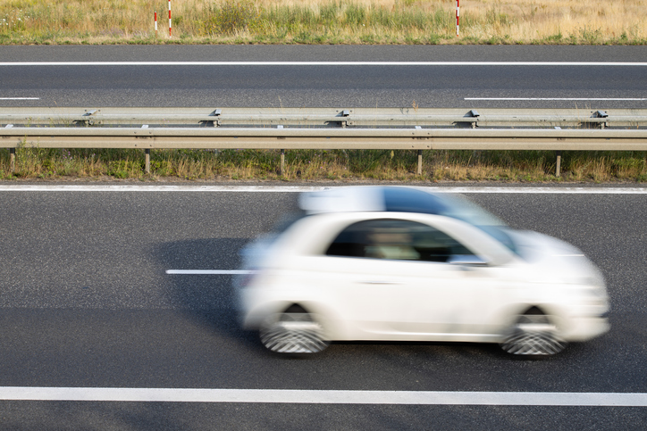 Fast white car on a country road
